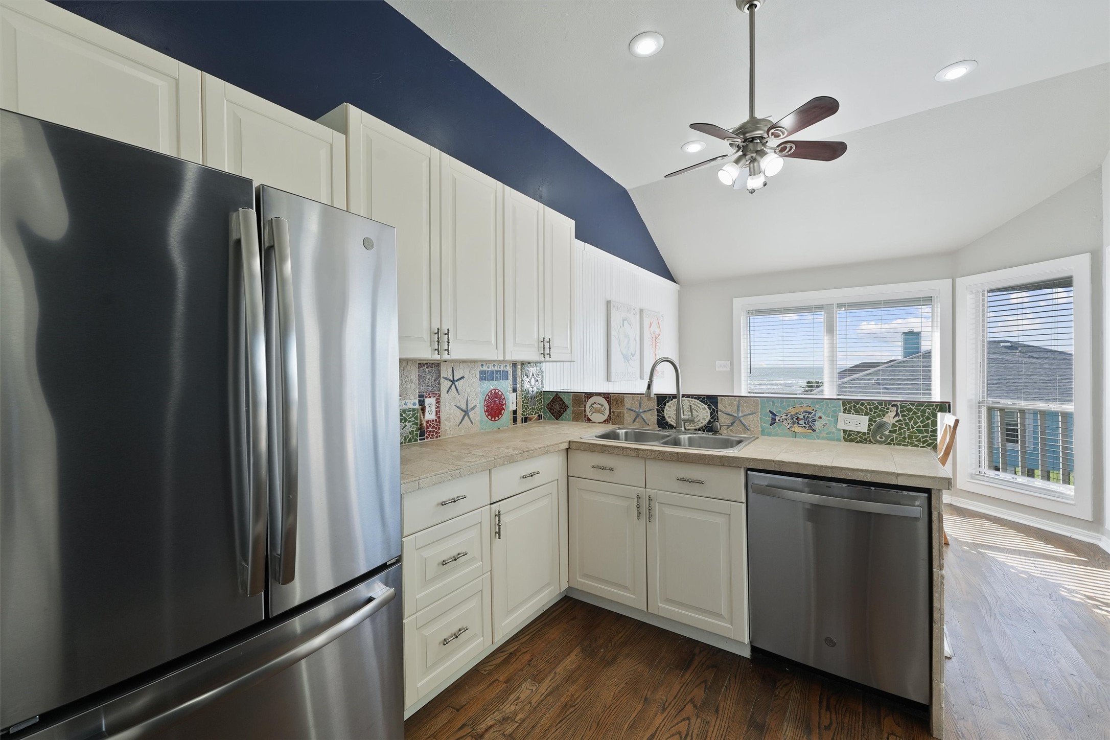 17607 Termini-San Luis Pass Road Galveston, TX 77554 - Photo 14 of 42 The kitchen’s bright and welcoming design includes a large sink with a view out to the dining area. Natural light floods the space, creating a cheerful environment for preparing meals.