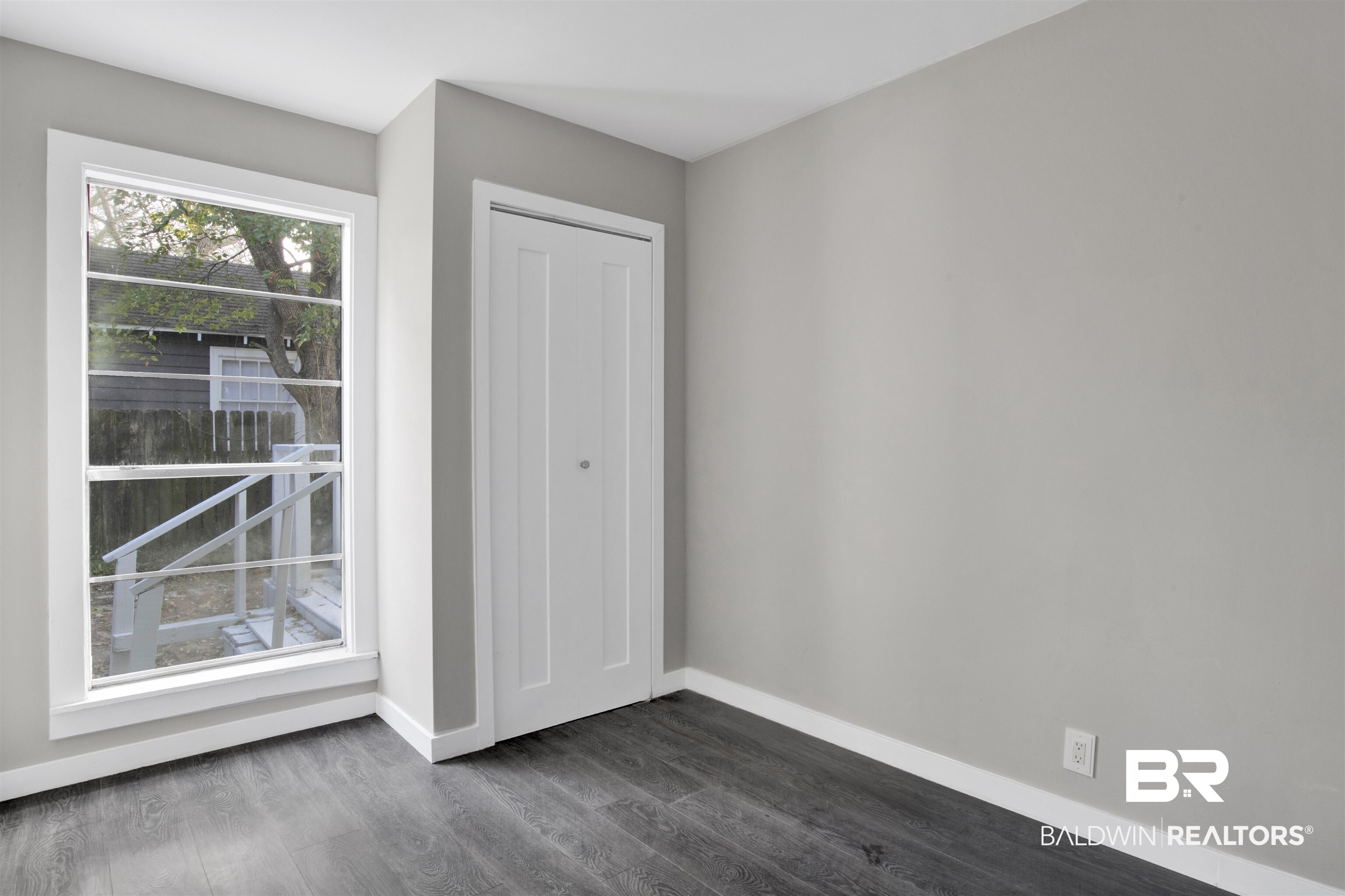 1063 Selma Street Mobile, AL 36604 - Photo 17 of 32 Unfurnished bedroom featuring dark wood-type flooring and a closet
