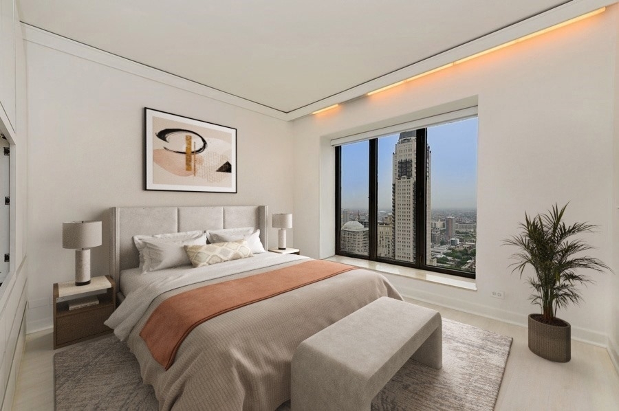 950 North Michigan Avenue, Unit 4003 Chicago, IL 60611 - Photo 13 of 28 a bedroom with a large bed and a potted plant