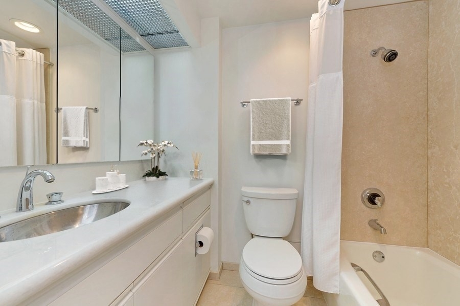 950 North Michigan Avenue, Unit 4003 Chicago, IL 60611 - Photo 14 of 28 a bathroom with a sink a toilet and shower