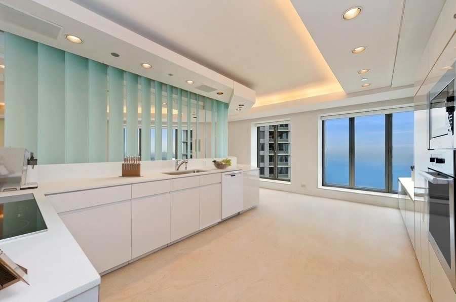 950 North Michigan Avenue, Unit 4003 Chicago, IL 60611 - Photo 4 of 28 a large white room with a large window and furniture