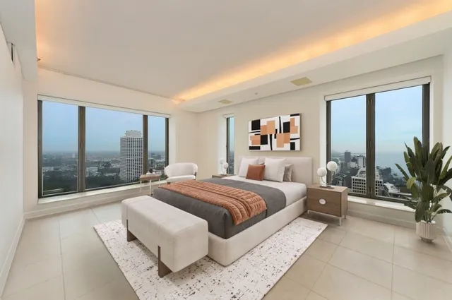 a bedroom with a large bed and a large window