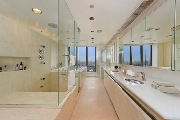 a large bathroom with a double vanity sink toilet mirror and bathtub