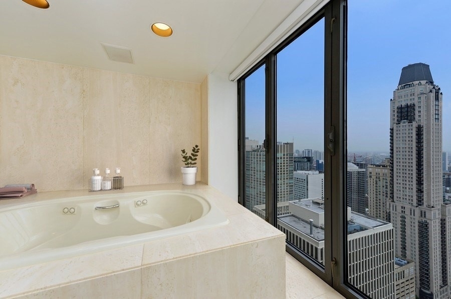 950 North Michigan Avenue, Unit 4003 Chicago, IL 60611 - Photo 10 of 28 a bathroom with a sink and a mirror
