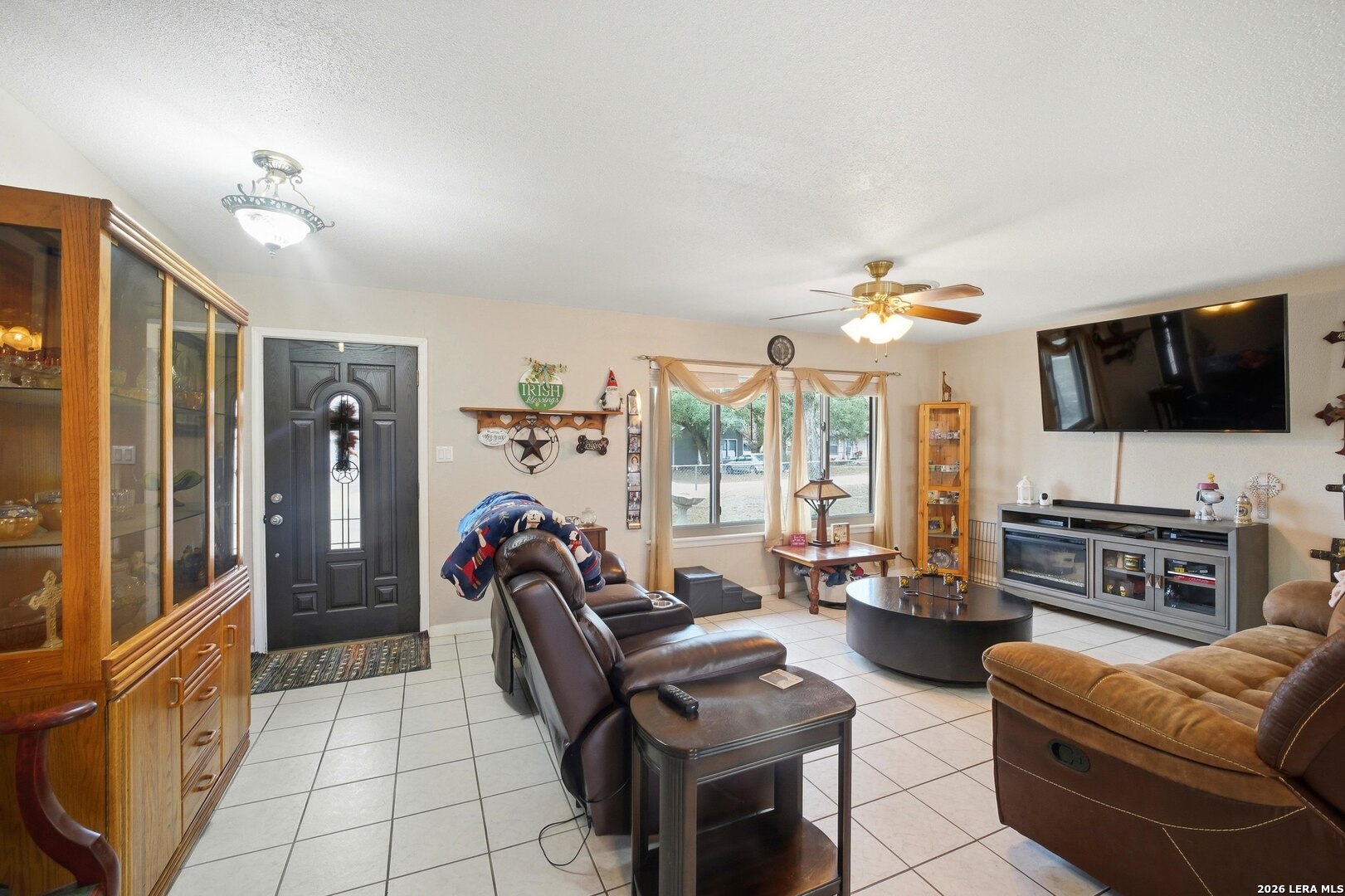 15047 Mesquite Street Lytle, TX 78052 - Photo 15 of 34 a living room with furniture and a flat screen tv