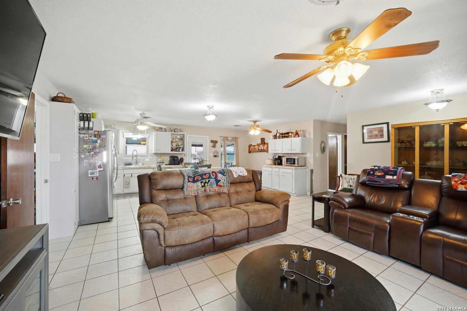 15047 Mesquite Street Lytle, TX 78052 - Photo 16 of 34 a living room with furniture and a flat screen tv