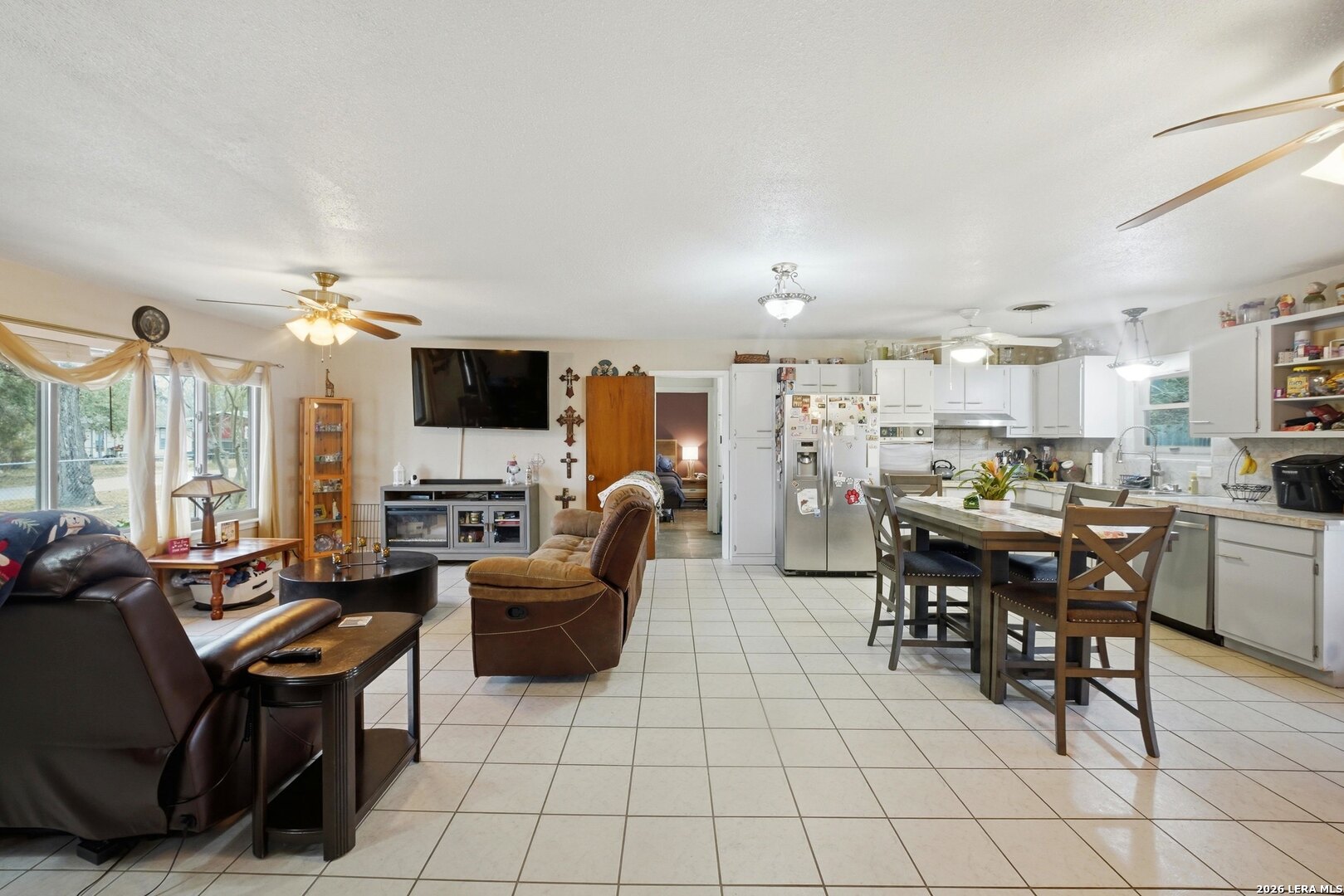 15047 Mesquite Street Lytle, TX 78052 - Photo 18 of 34 a living room with furniture and a flat screen tv
