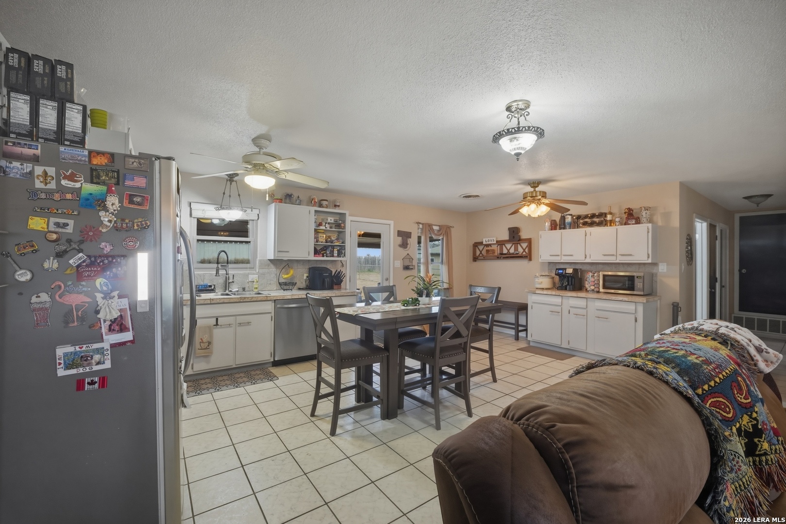 15047 Mesquite Street Lytle, TX 78052 - Photo 19 of 34 a living room with stainless steel appliances furniture and a kitchen view