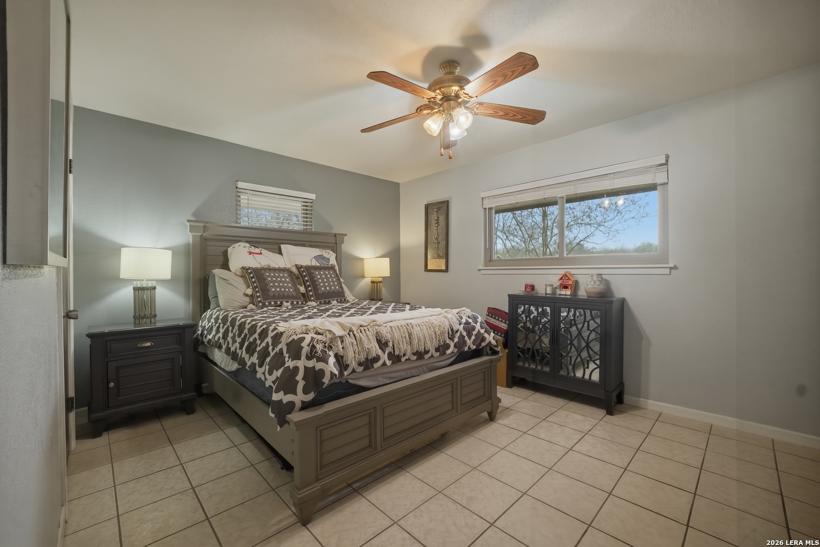 15047 Mesquite Street Lytle, TX 78052 - Photo 26 of 34 a bedroom with a bed and a chandelier