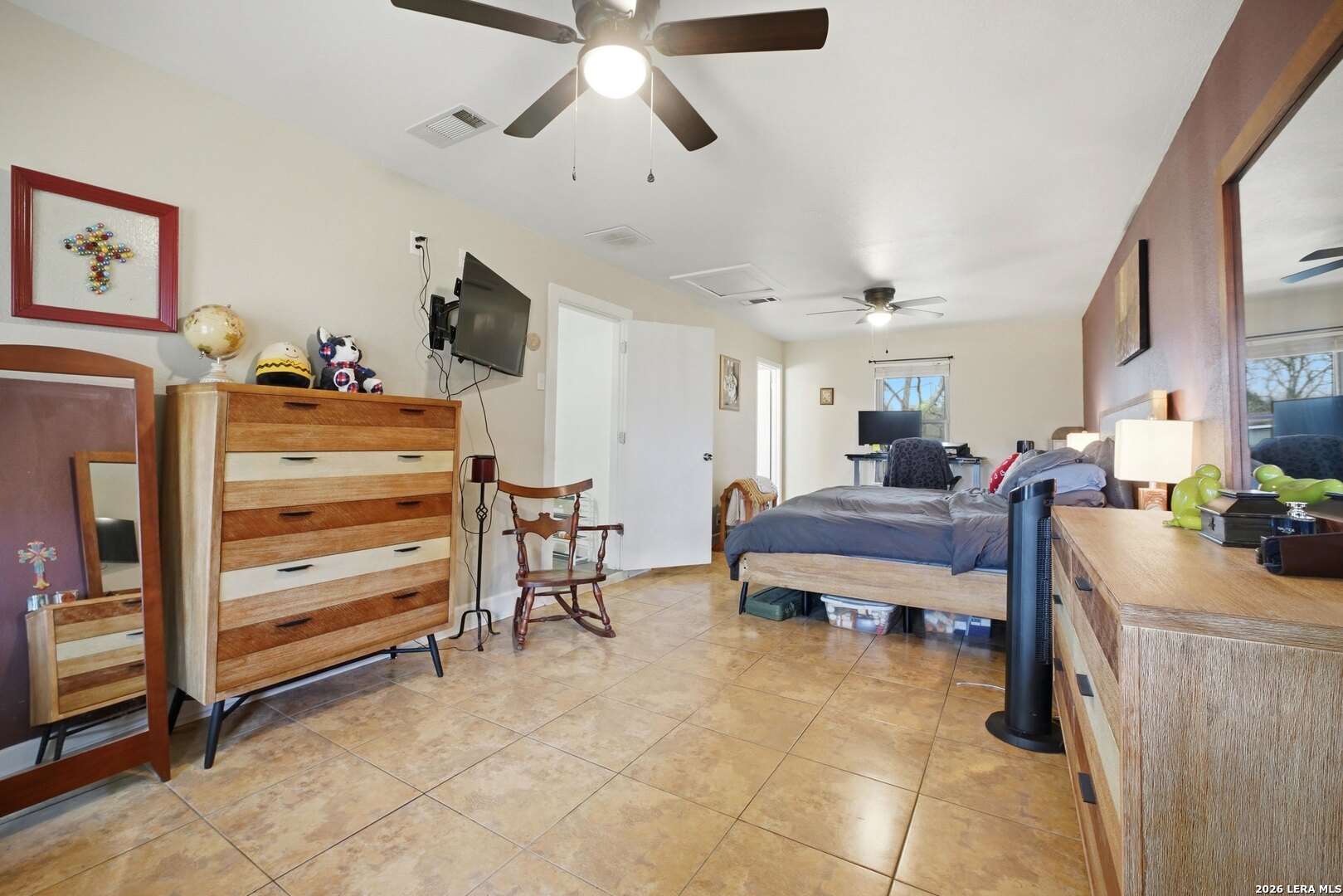 15047 Mesquite Street Lytle, TX 78052 - Photo 29 of 34 a living room with furniture and a flat screen tv