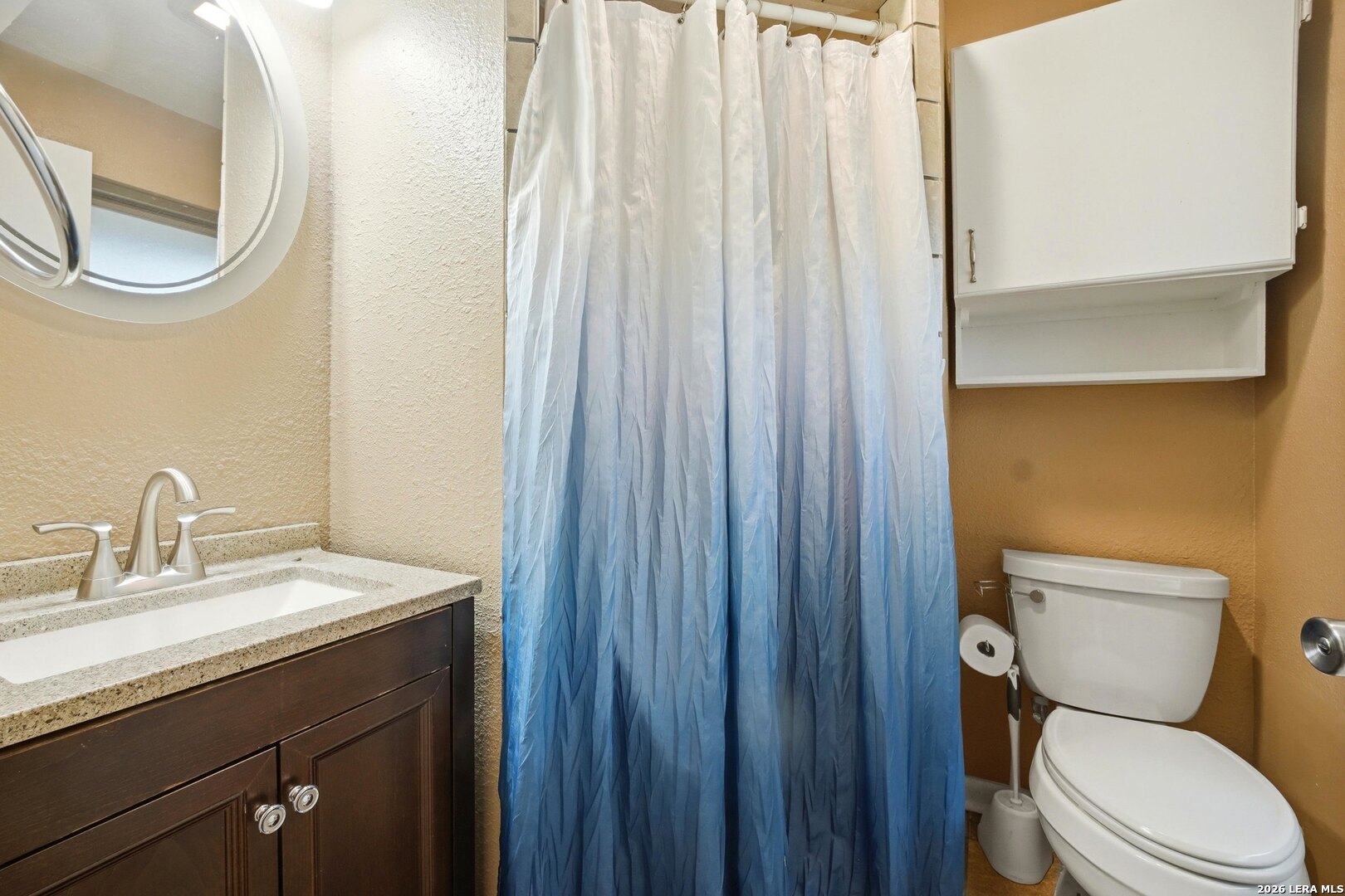 15047 Mesquite Street Lytle, TX 78052 - Photo 31 of 34 a bathroom with a toilet a sink and a mirror