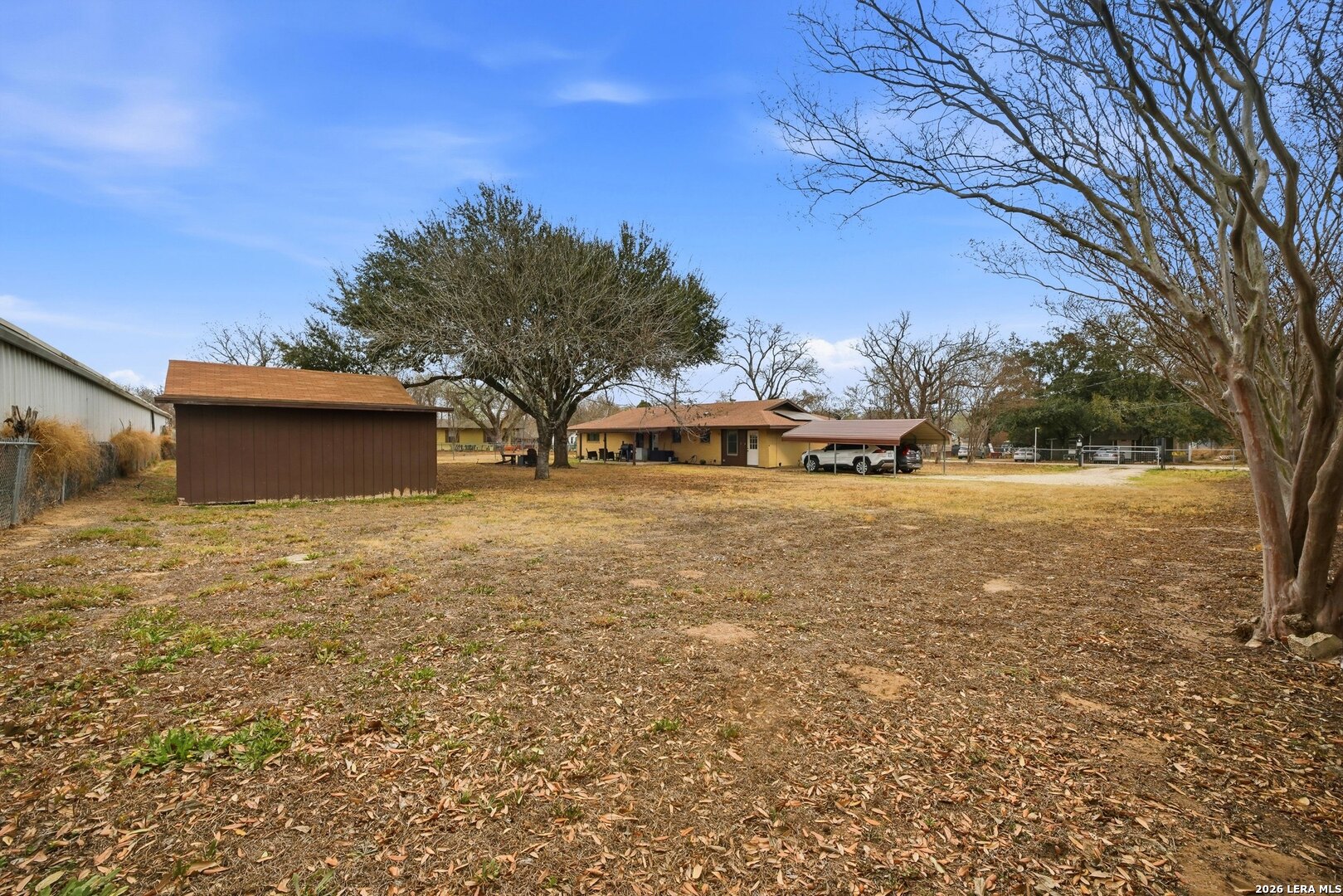 15047 Mesquite Street Lytle, TX 78052 - Photo 33 of 34 a view of a house with a yard