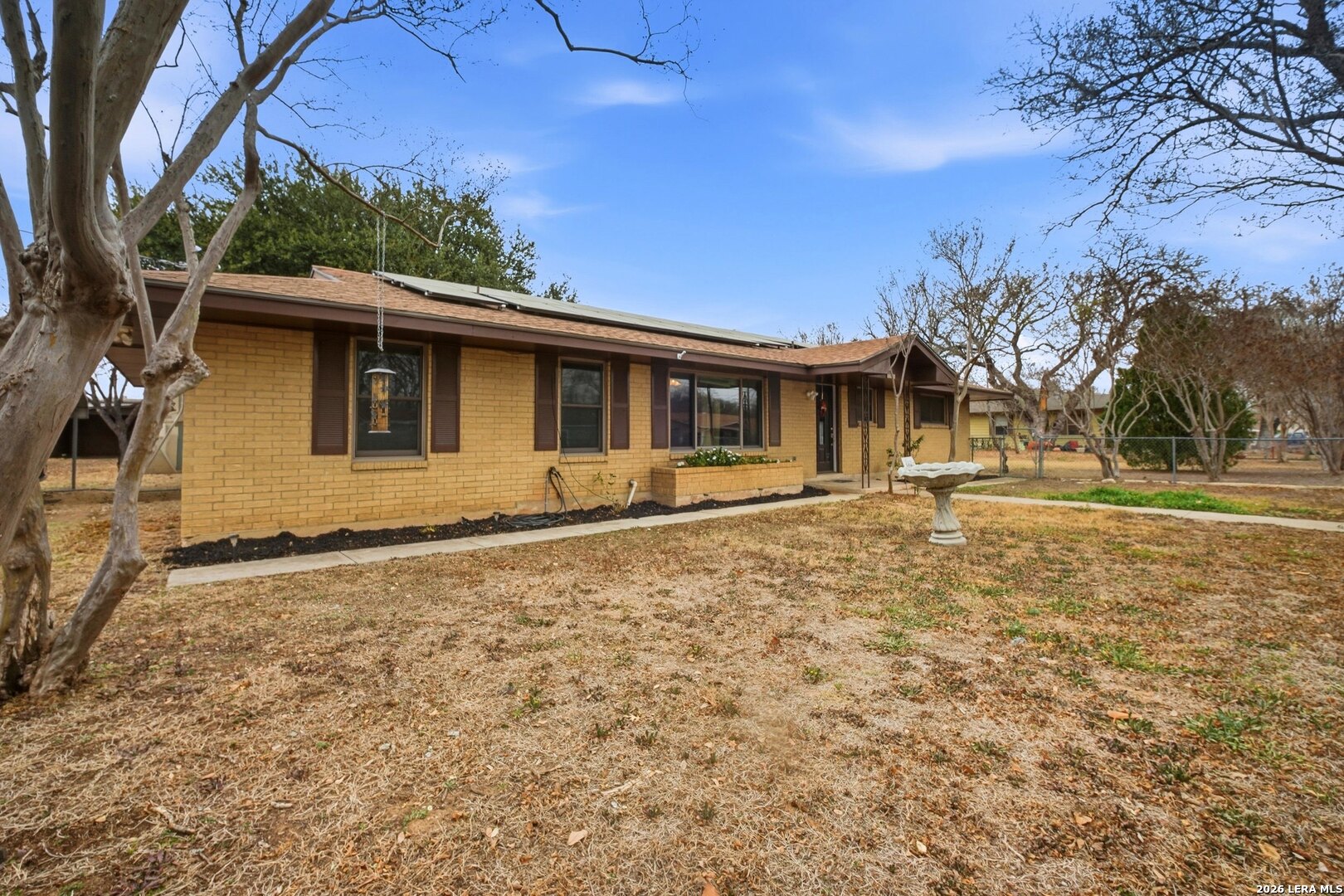 15047 Mesquite Street Lytle, TX 78052 - Photo 4 of 34 a front view of a house with a yard