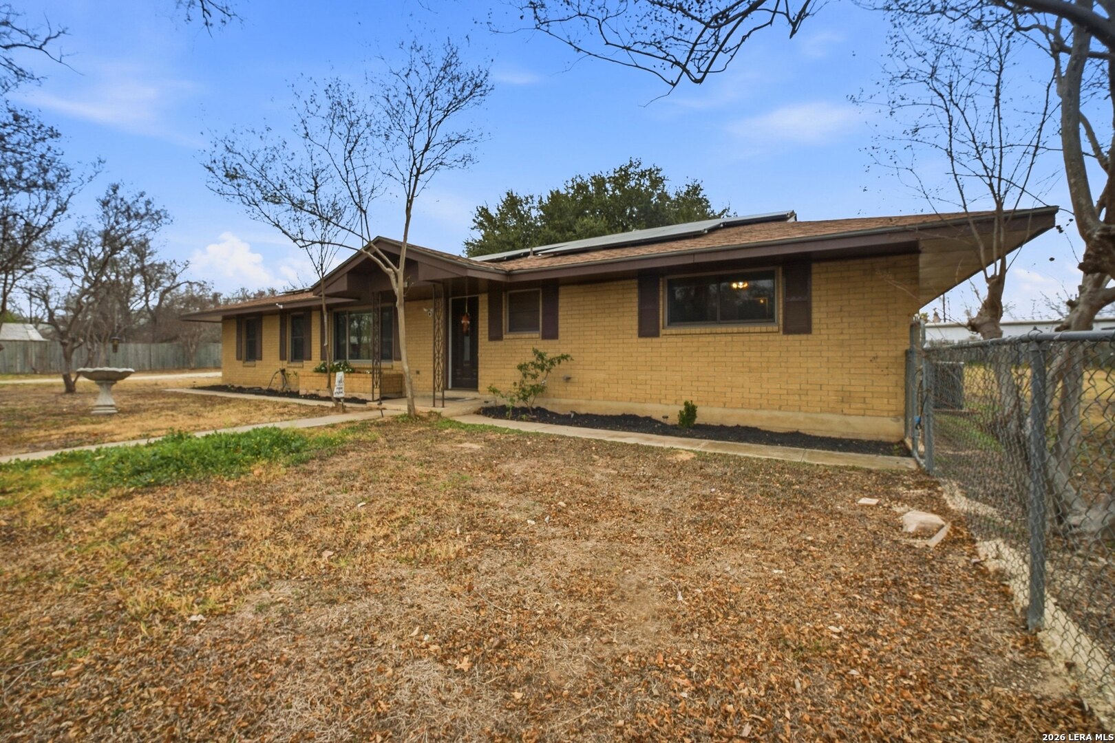 15047 Mesquite Street Lytle, TX 78052 - Photo 5 of 34 a view of a house with backyard and trees