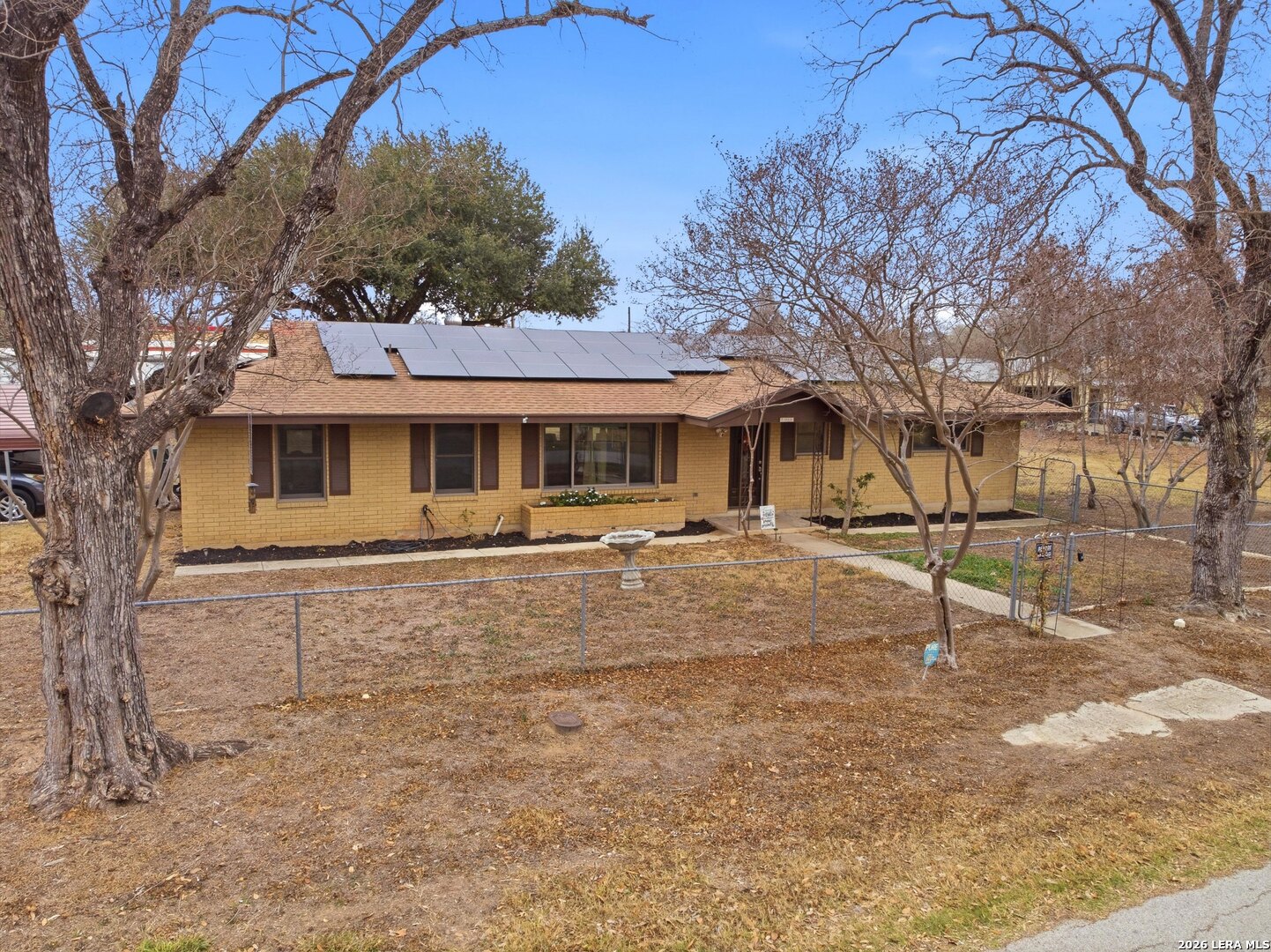 15047 Mesquite Street Lytle, TX 78052 - Photo 8 of 34 a front view of a house with a yard