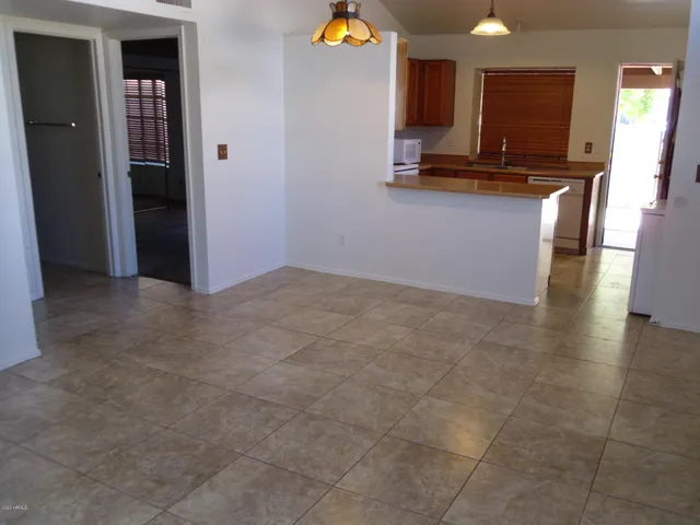 a view of kitchen with stainless steel appliances granite countertop a stove and a sink