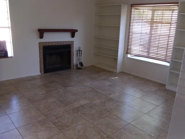 a view of empty room with a fireplace