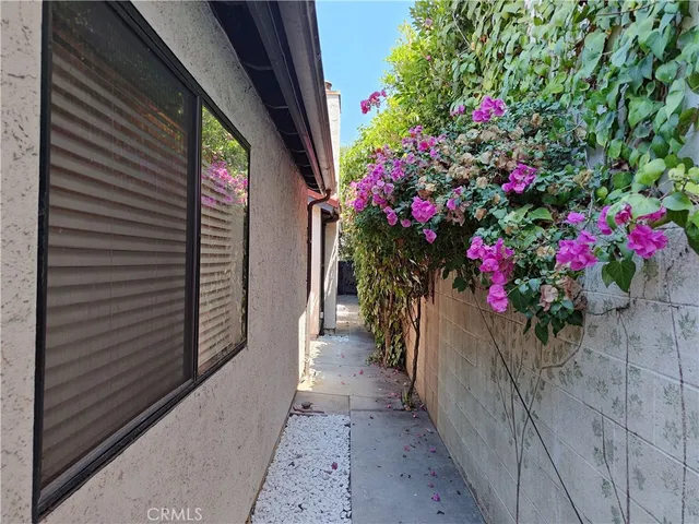 a view of a house with a flower garden