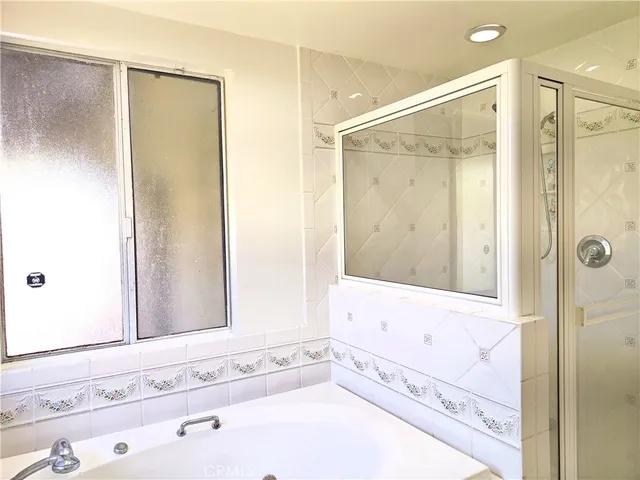 a bathroom with a bathtub and a shower