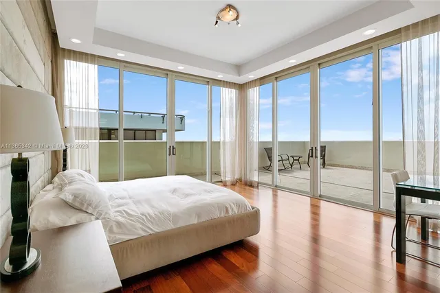 a bedroom with a bed and large window