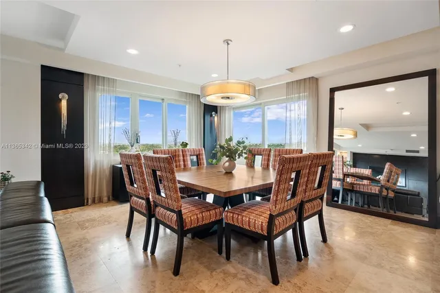 a dining room with furniture window and wooden floor
