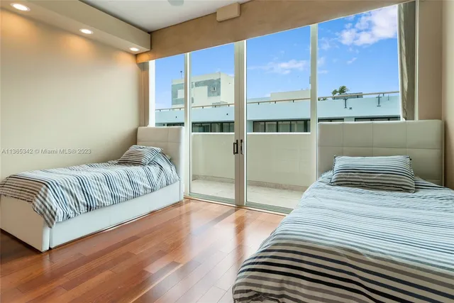 a bedroom with a bed and a large window