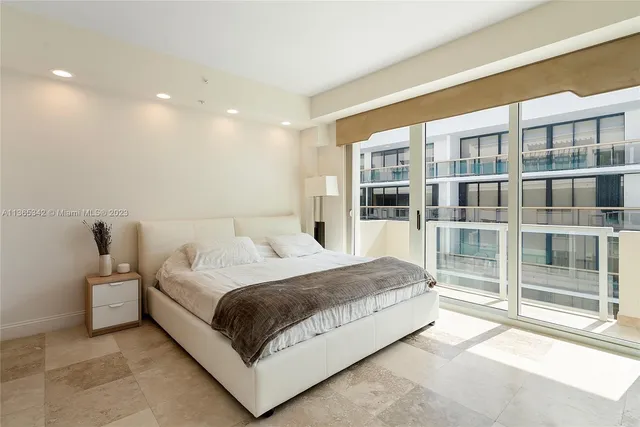 a bedroom with a large bed and a large window