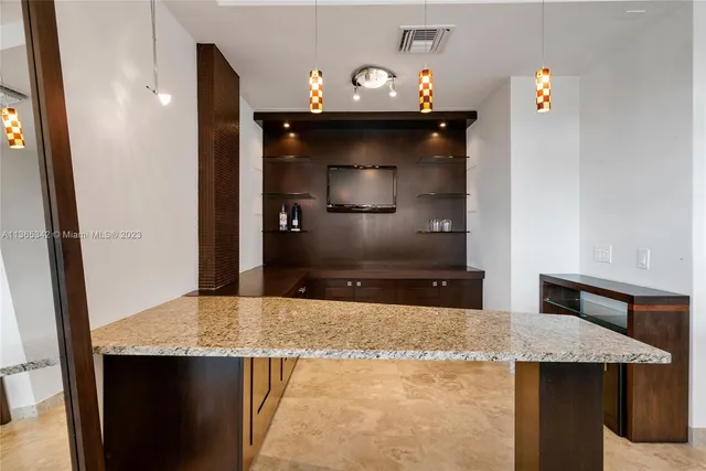 a kitchen with a sink a microwave and refrigerator