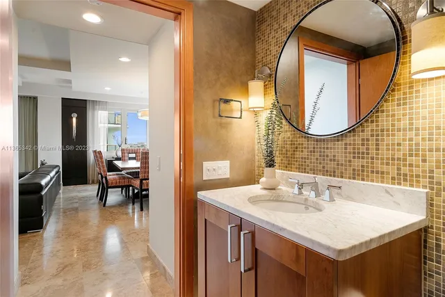 a bathroom with a sink a vanity and a mirror