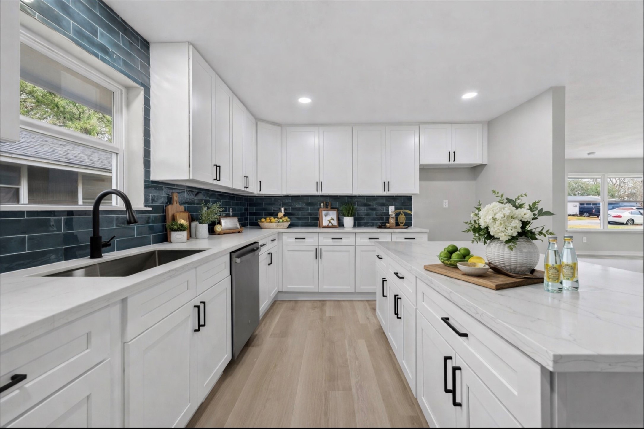 6026 Ridgeway Drive Houston, TX 77033 - Photo 1 of 27 a kitchen with white cabinets and white appliances
