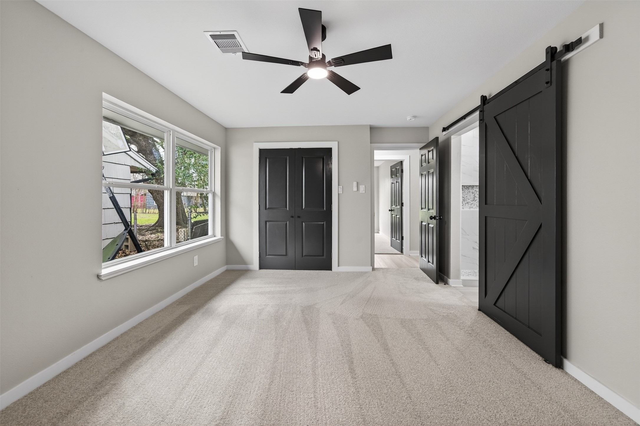 6026 Ridgeway Drive Houston, TX 77033 - Photo 20 of 27 a view of an empty room with a window and a kitchen
