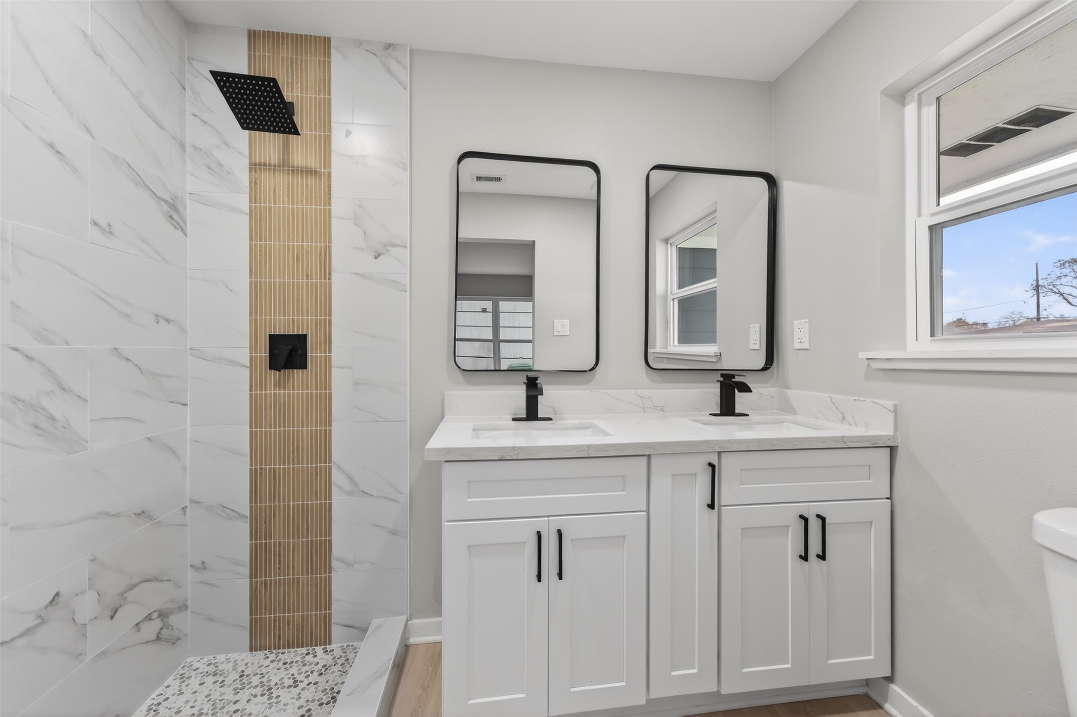 6026 Ridgeway Drive Houston, TX 77033 - Photo 21 of 27 a bathroom with a double vanity sink and mirror