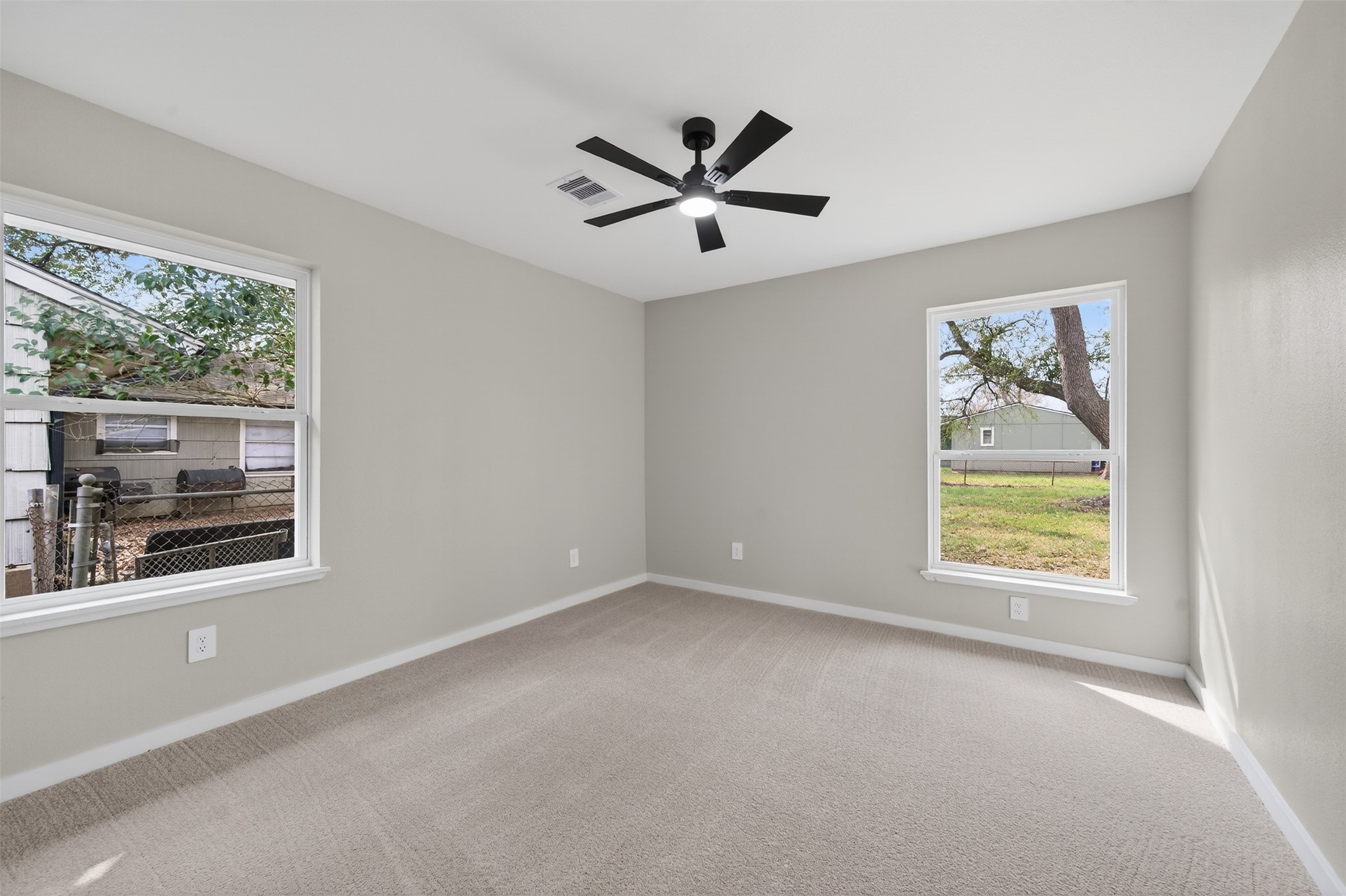 6026 Ridgeway Drive Houston, TX 77033 - Photo 23 of 27 an empty room with windows and fan