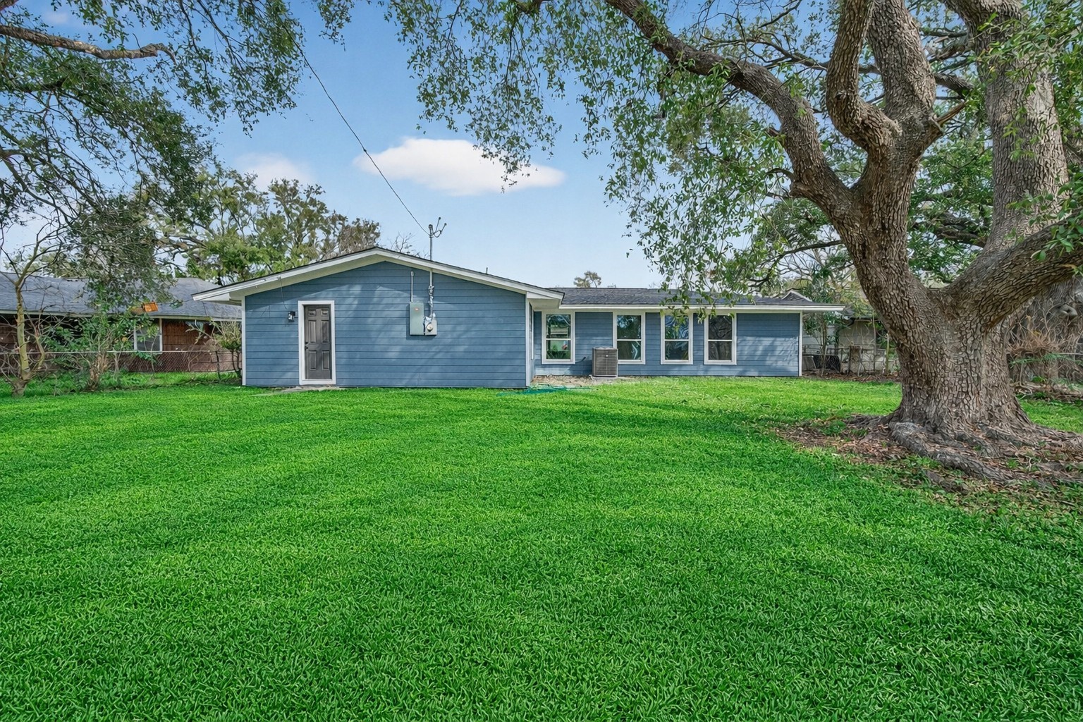 6026 Ridgeway Drive Houston, TX 77033 - Photo 25 of 27 a view of a house with a yard and large tree