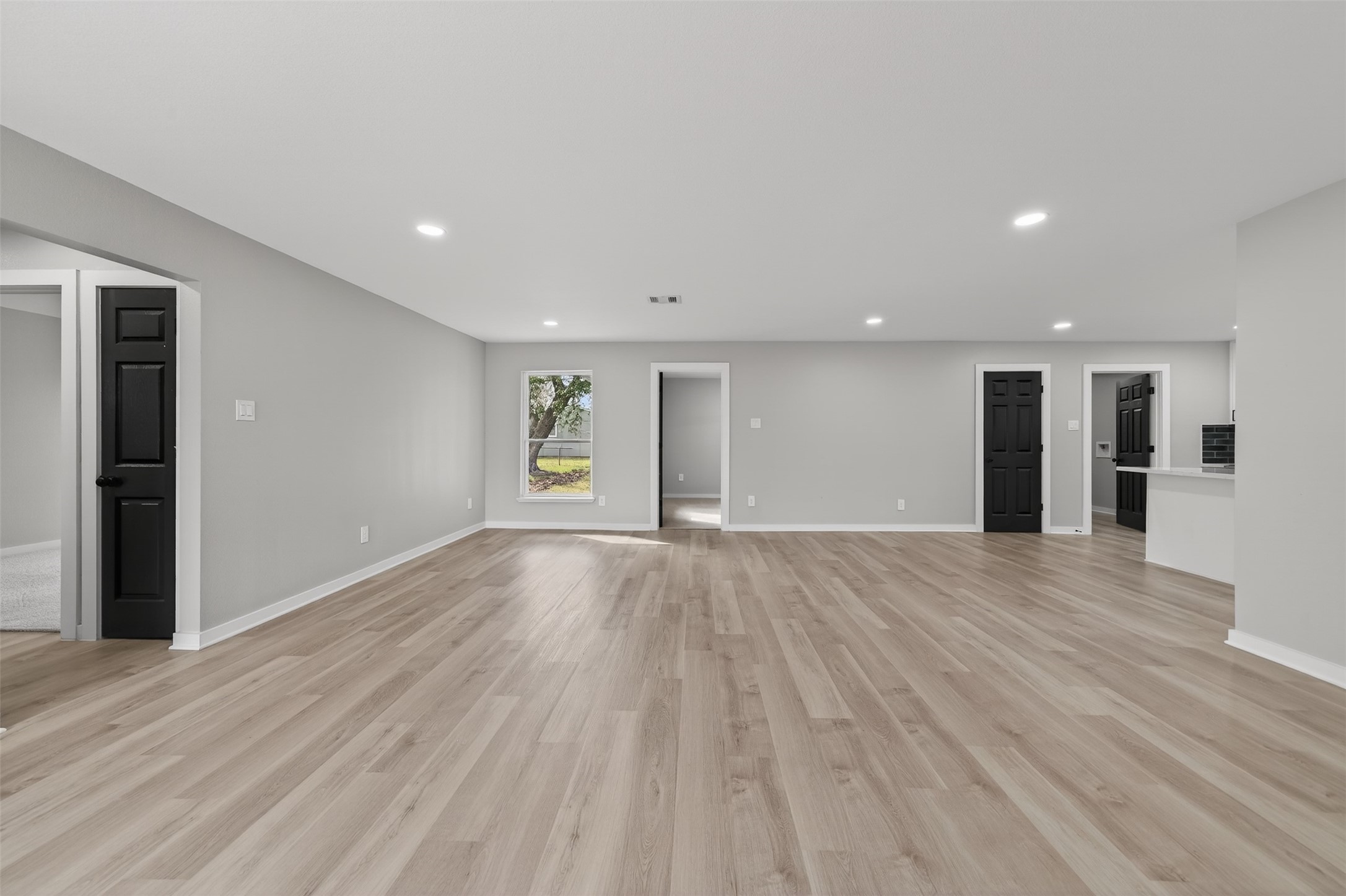 6026 Ridgeway Drive Houston, TX 77033 - Photo 7 of 27 a view of an empty room with wooden floor and a window