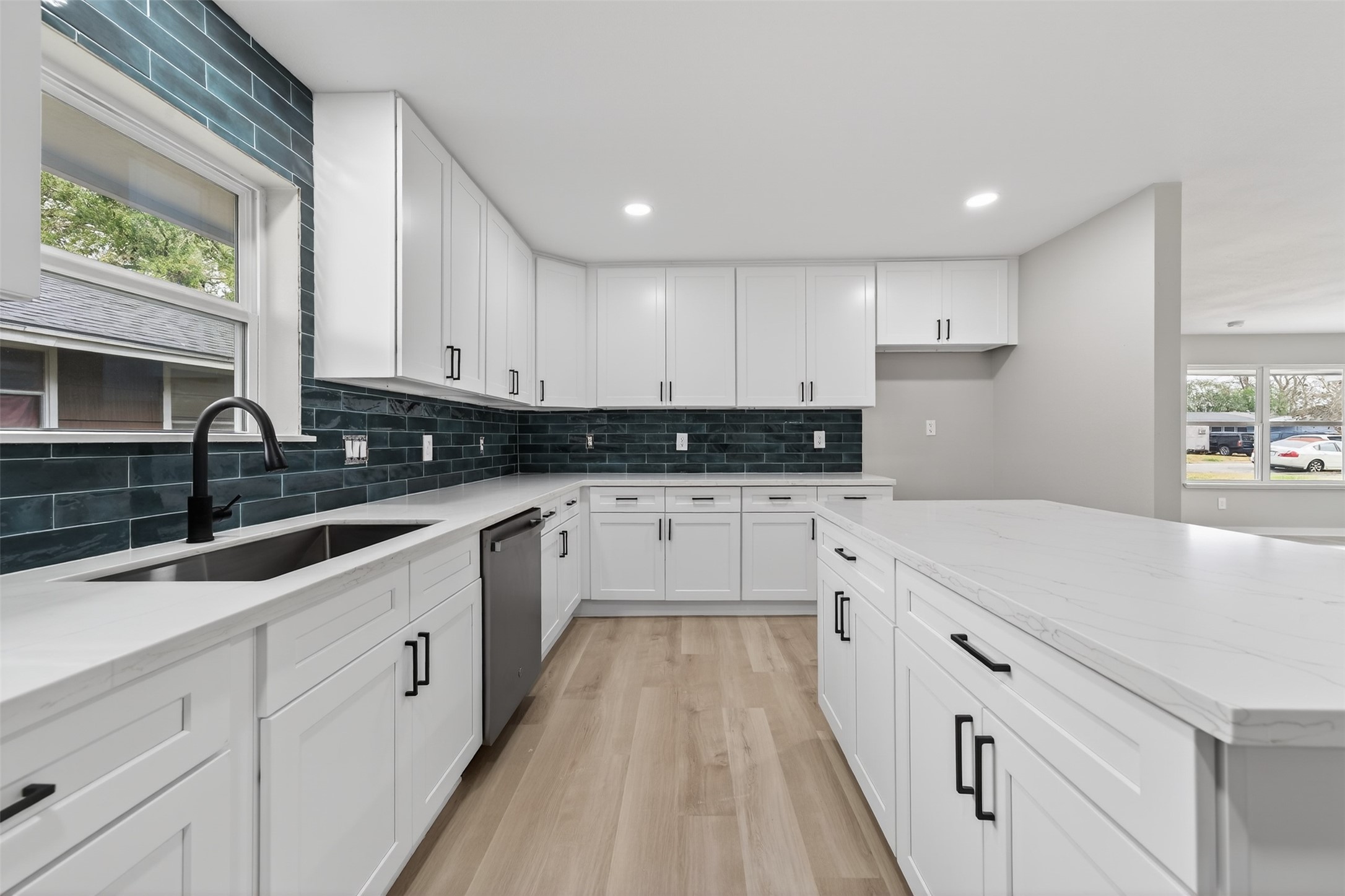 6026 Ridgeway Drive Houston, TX 77033 - Photo 10 of 27 a kitchen with granite countertop white cabinets white stainless steel appliances and sink