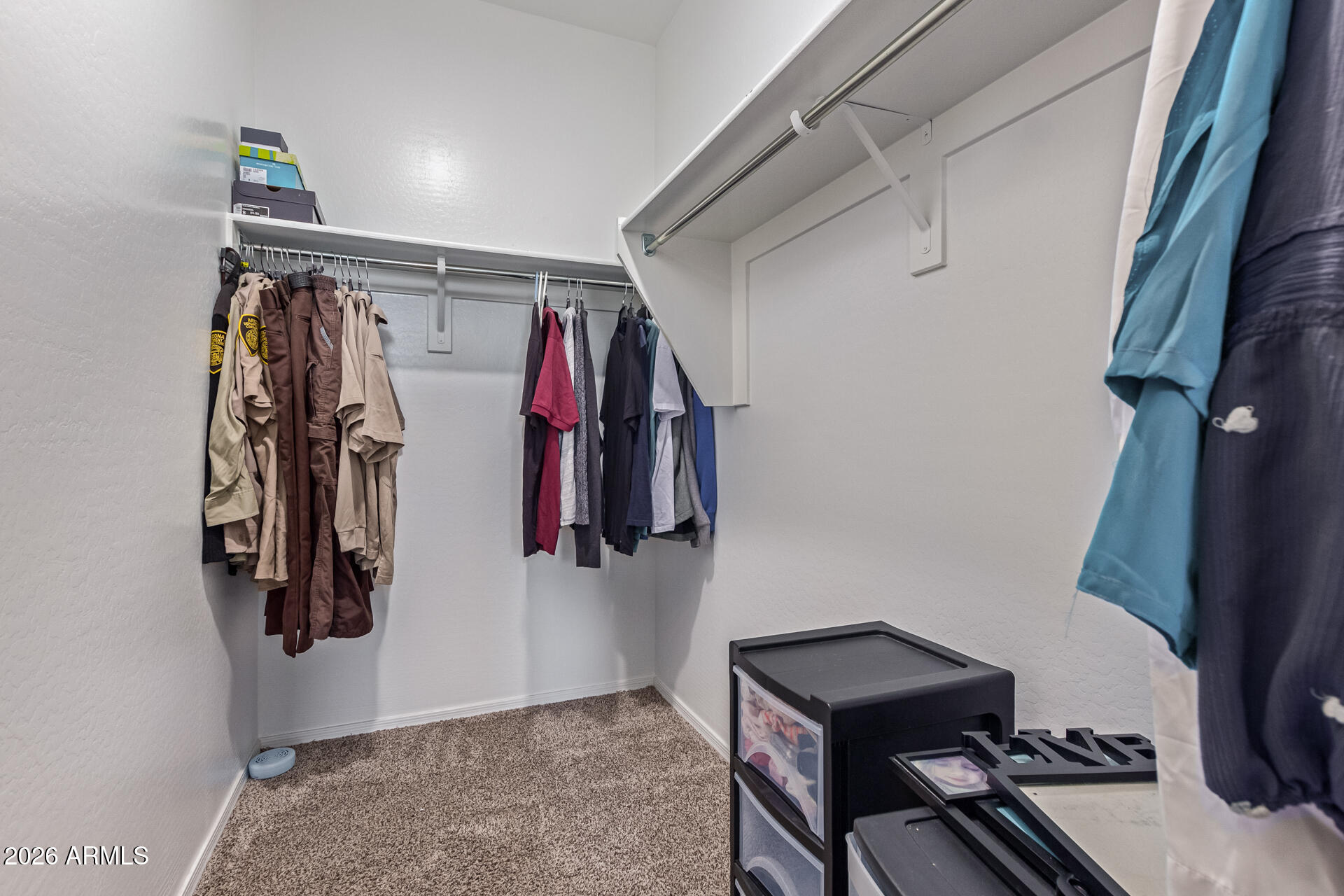 3847 North 308th Lane Buckeye, AZ 85396 - Photo 20 of 32 a view of walk in closet with clothes and shoes