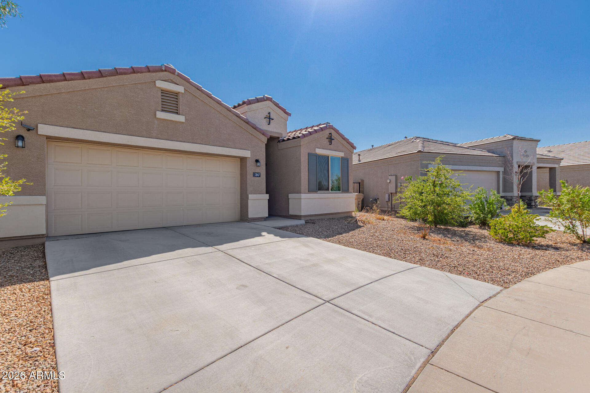 3847 North 308th Lane Buckeye, AZ 85396 - Photo 2 of 32 a front view of a house with a yard and garage