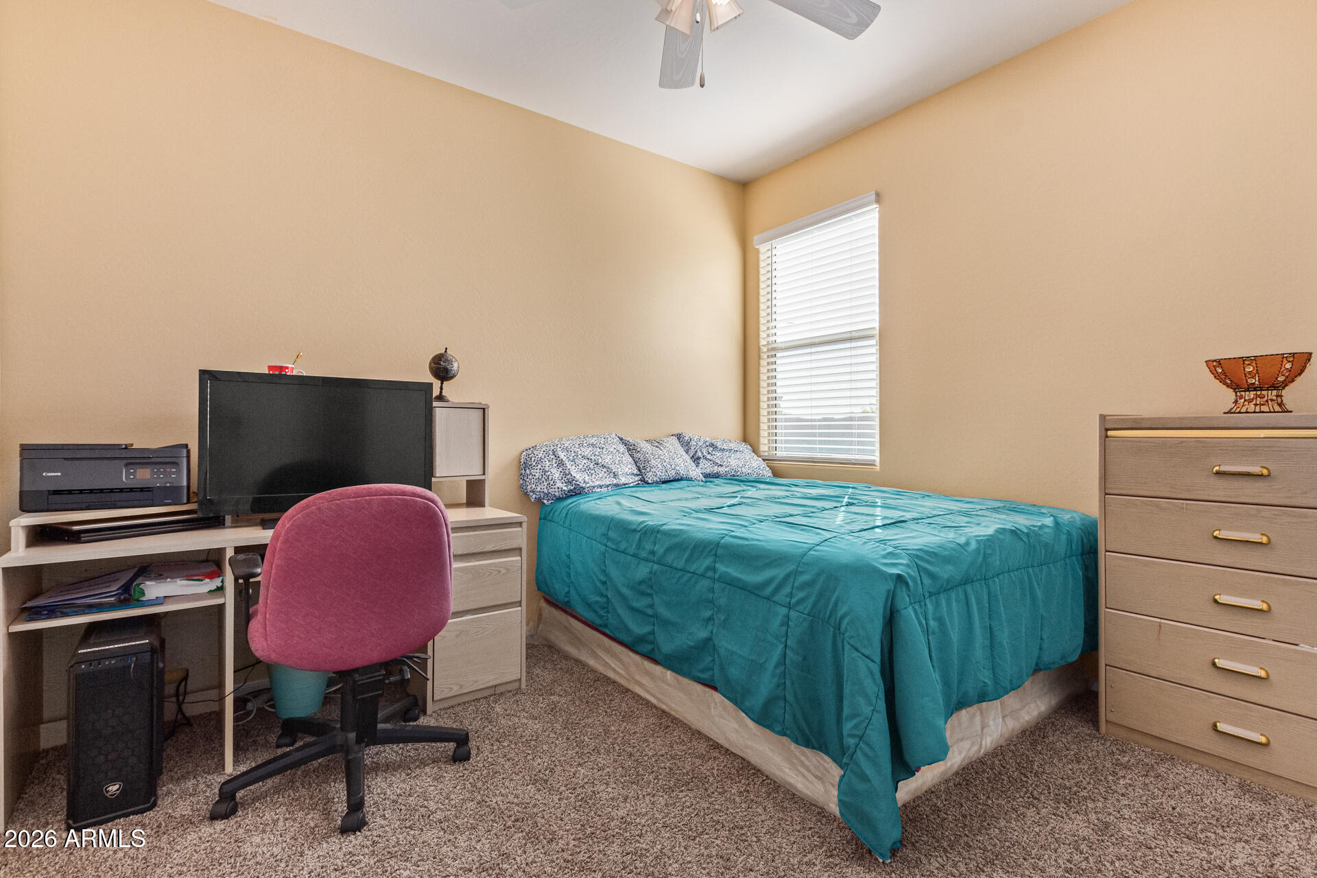 3847 North 308th Lane Buckeye, AZ 85396 - Photo 24 of 32 a bedroom with a bed and a chair with chandelier