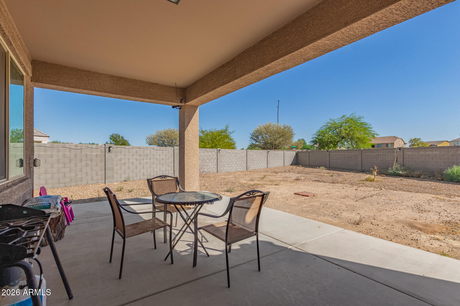 3847 North 308th Lane Buckeye, AZ 85396 - Photo 26 of 32 a view of a backyard with furniture and a garden
