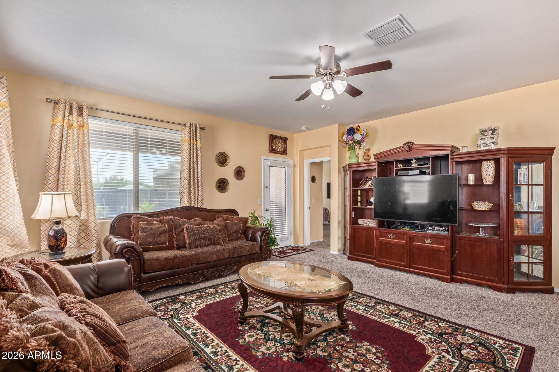 3847 North 308th Lane Buckeye, AZ 85396 - Photo 10 of 32 a living room with furniture and a flat screen tv