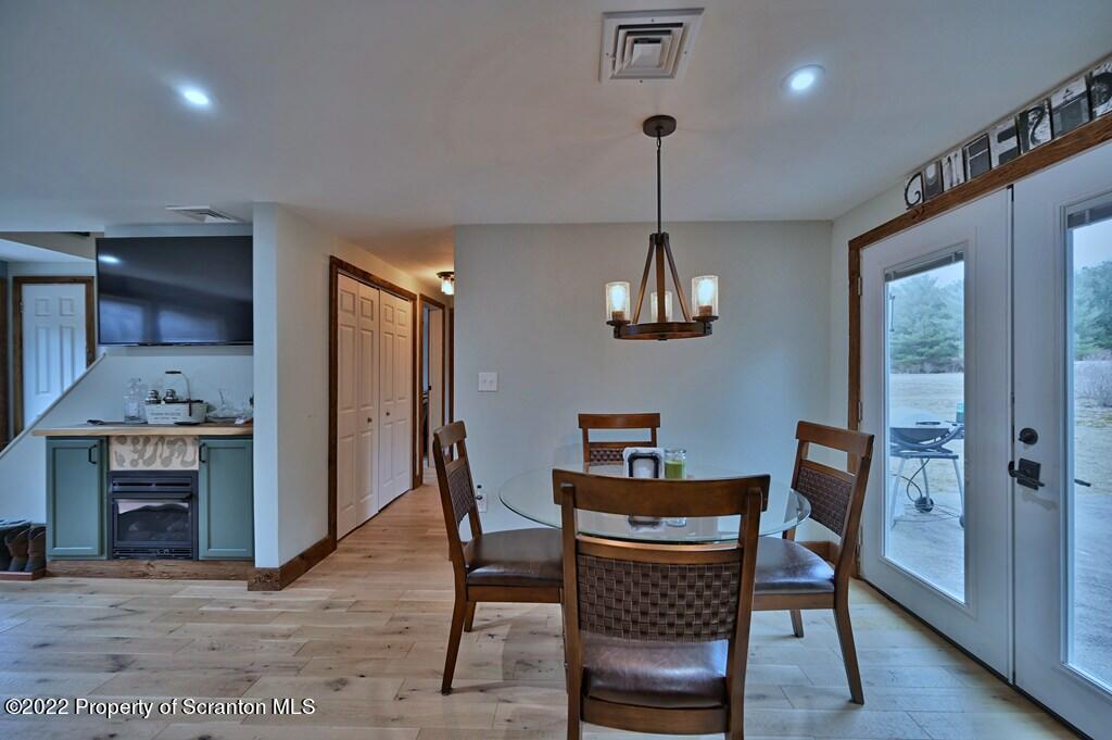22 Suetta Lane Moscow, PA 18444 - Photo 11 of 53 a view of a dining room with furniture wooden floor and chandelier
