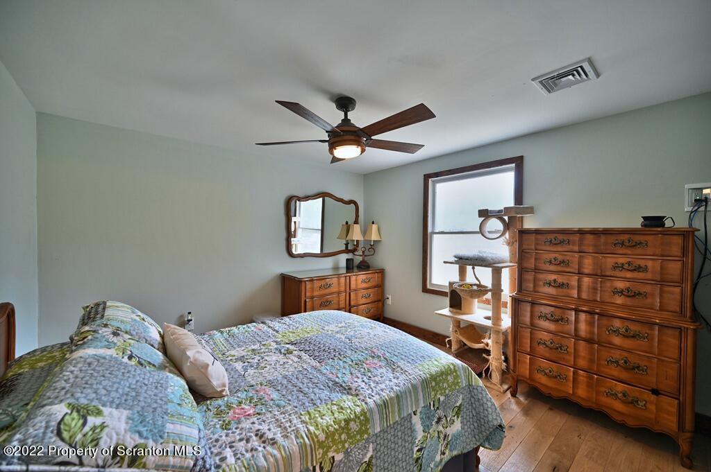 22 Suetta Lane Moscow, PA 18444 - Photo 22 of 53 a bedroom with a bed and a dresser in it