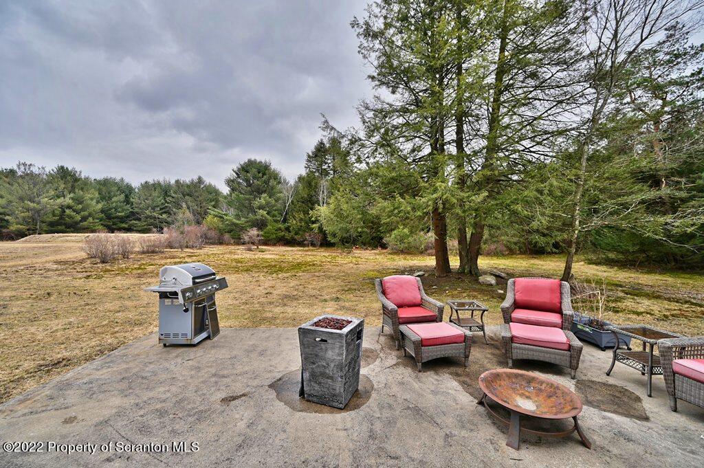 22 Suetta Lane Moscow, PA 18444 - Photo 42 of 53 a backyard of a house with fire pit and outdoor seating