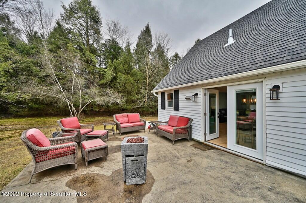 22 Suetta Lane Moscow, PA 18444 - Photo 43 of 53 a view of a patio with a table chairs and a backyard