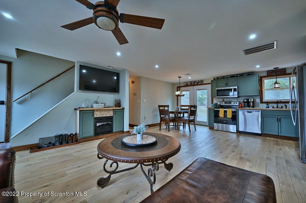 22 Suetta Lane Moscow, PA 18444 - Photo 5 of 53 a kitchen with a table chairs microwave and cabinets