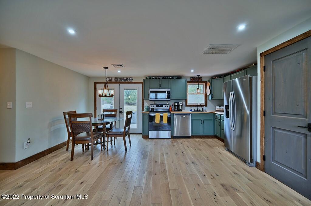 22 Suetta Lane Moscow, PA 18444 - Photo 6 of 53 a kitchen with a dining table chairs and refrigerator