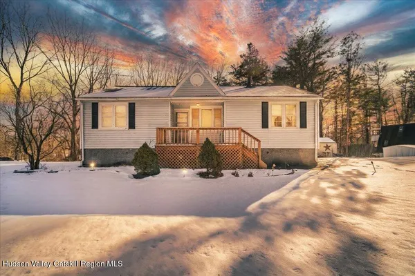 a view of a house with snow in the background