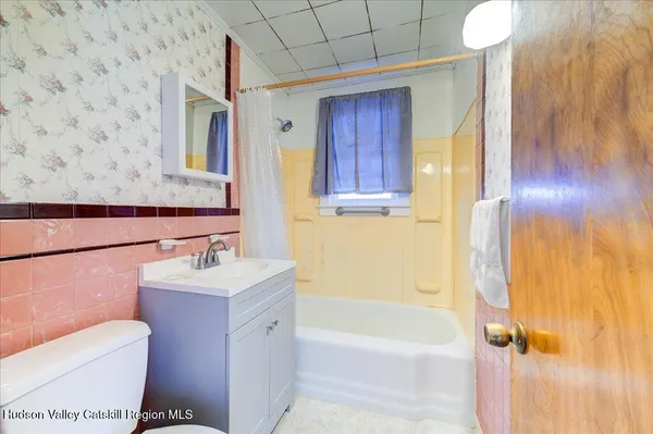 a bathroom with a sink mirror vanity and toilet
