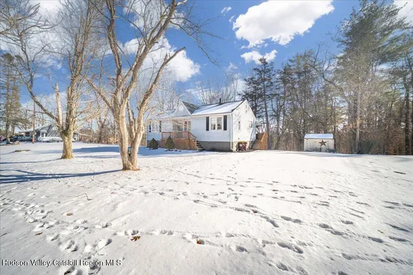 a view of a house with snow on the road